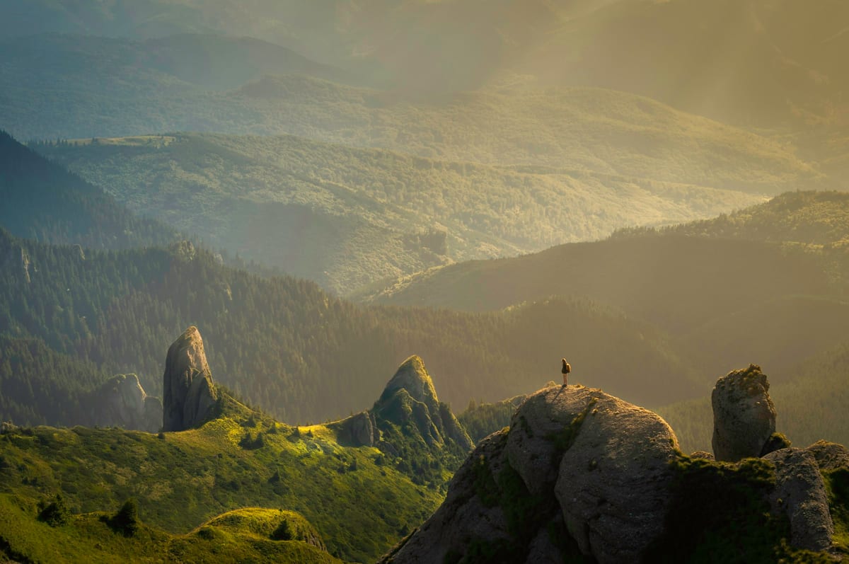 Layered mountain ridges in golden mist, evocative of Alberta’s foothills and Rockies.