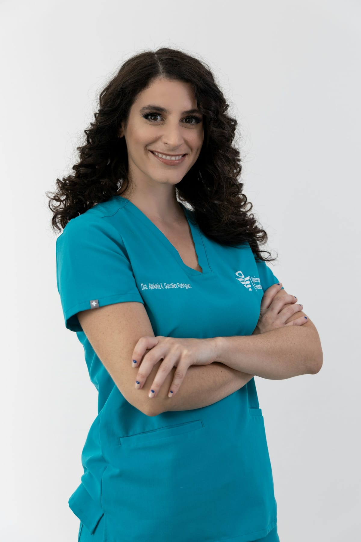 Example care team member: smiling professional in teal scrubs.
